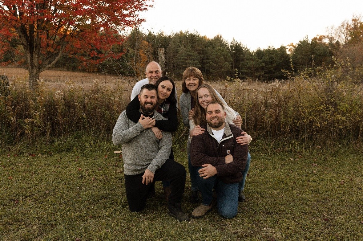 Family of six together among autumn trees